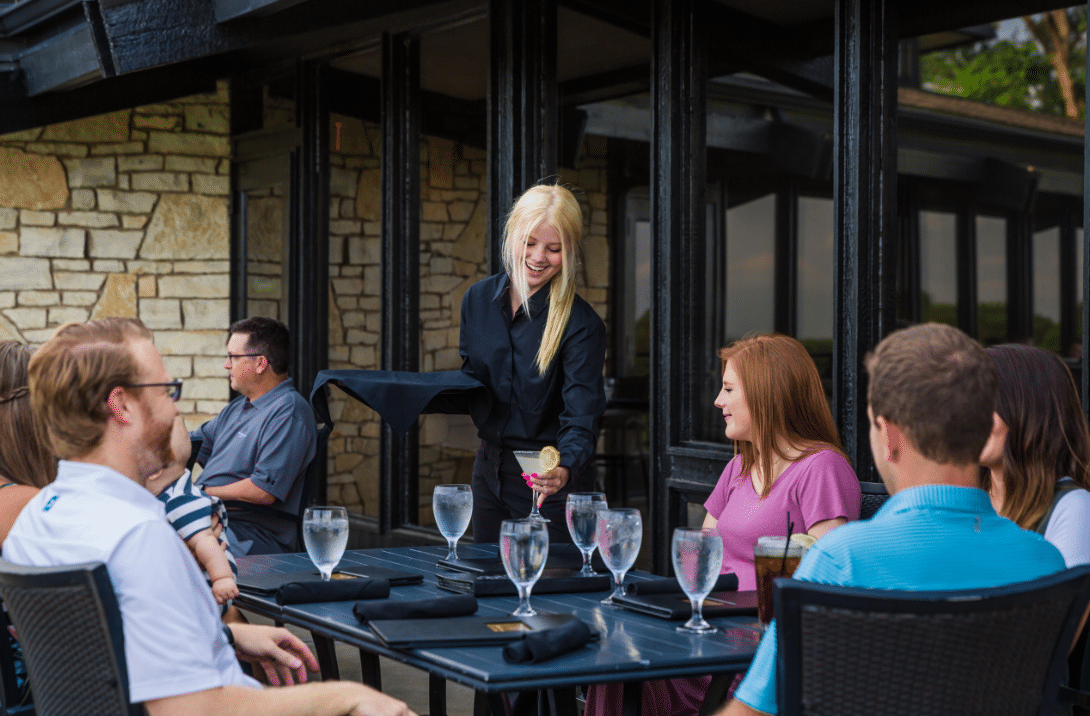 Waitress serving patrons during outdoor dining at Salina Country Club