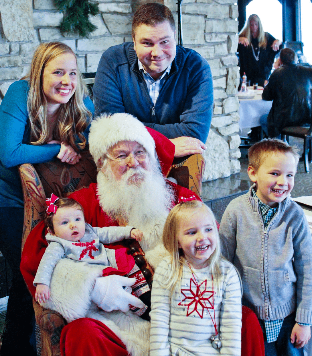 Family of 5 celebrating the holidays with Santa Claus at Salina Country Club