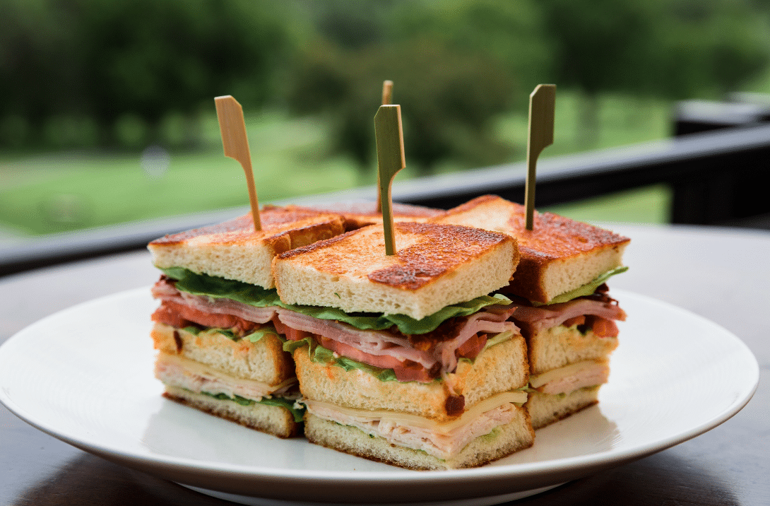 Club sandwiches arranged on a plate outdoors