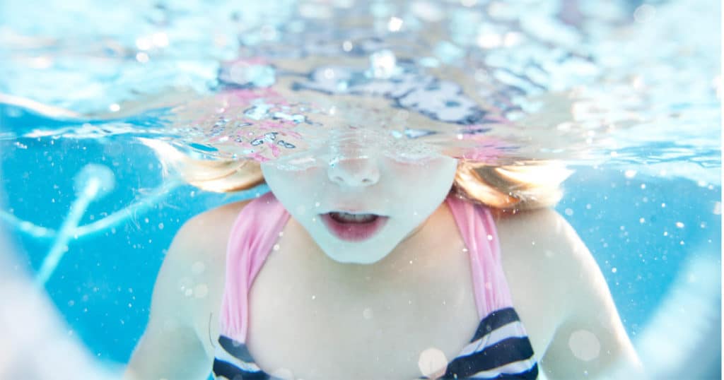 A little girl learning to swim at Salina Country Club's swimming pool