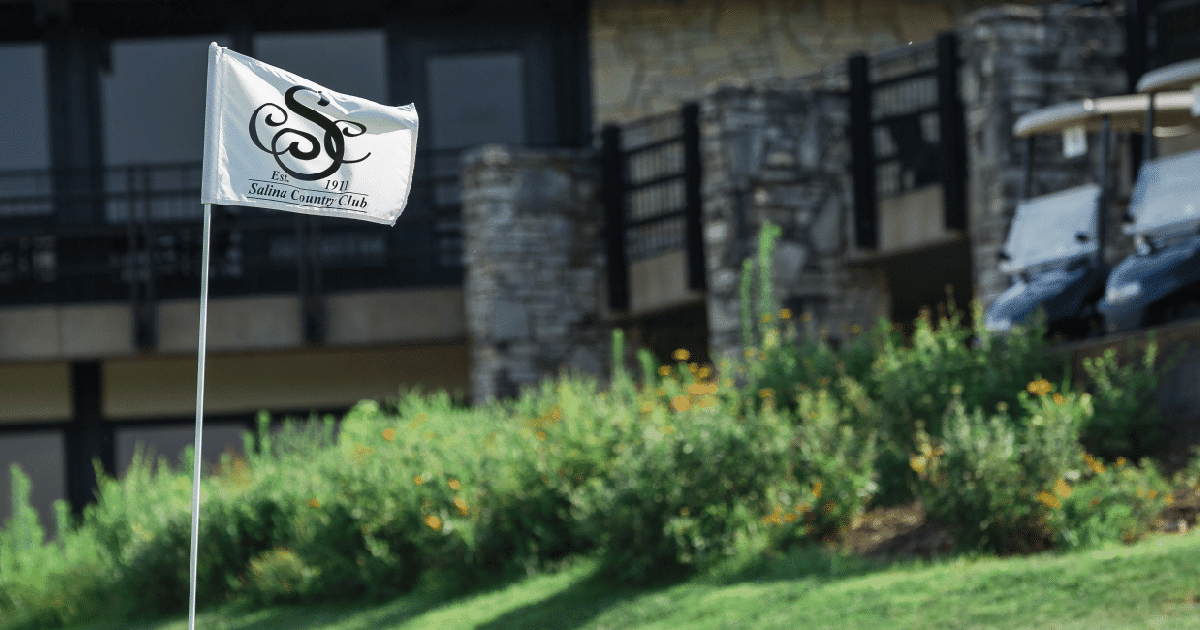 Salina Country Club logo displayed on flag outside of building